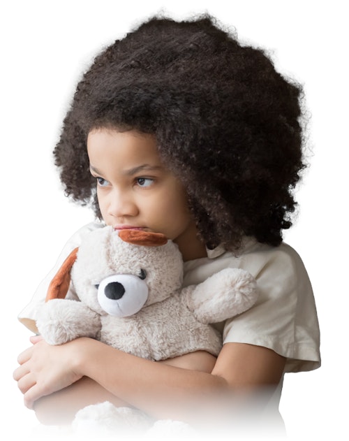 Young girl tightly holding teddy bear 