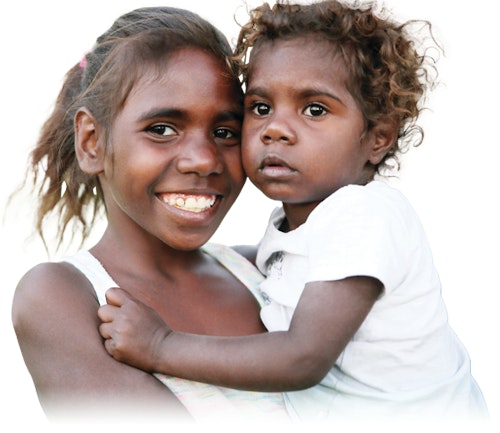 A young child holding a toddler