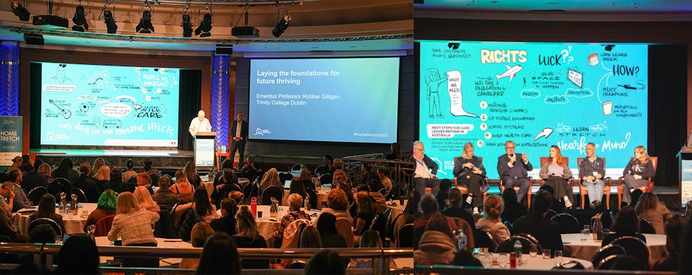 Wide shot of a panel discussion at the 2025 Home Stretch Symposium, showing speakers seated on stage with illustrated backdrop panels and a large audience in the foreground.