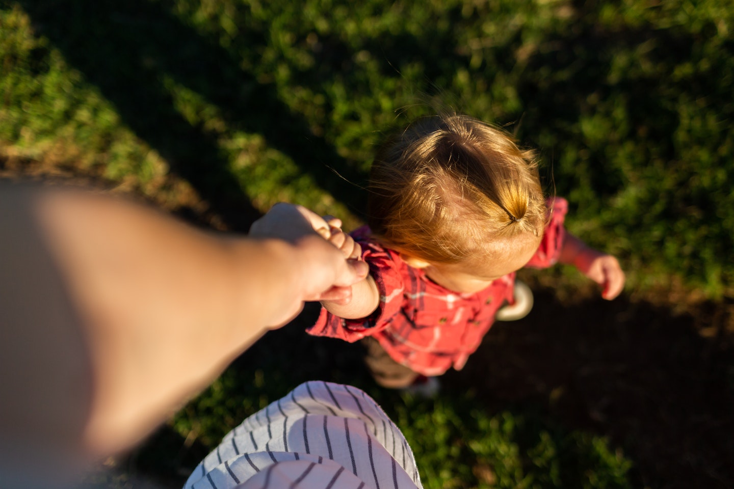 Young person holding hands with carer