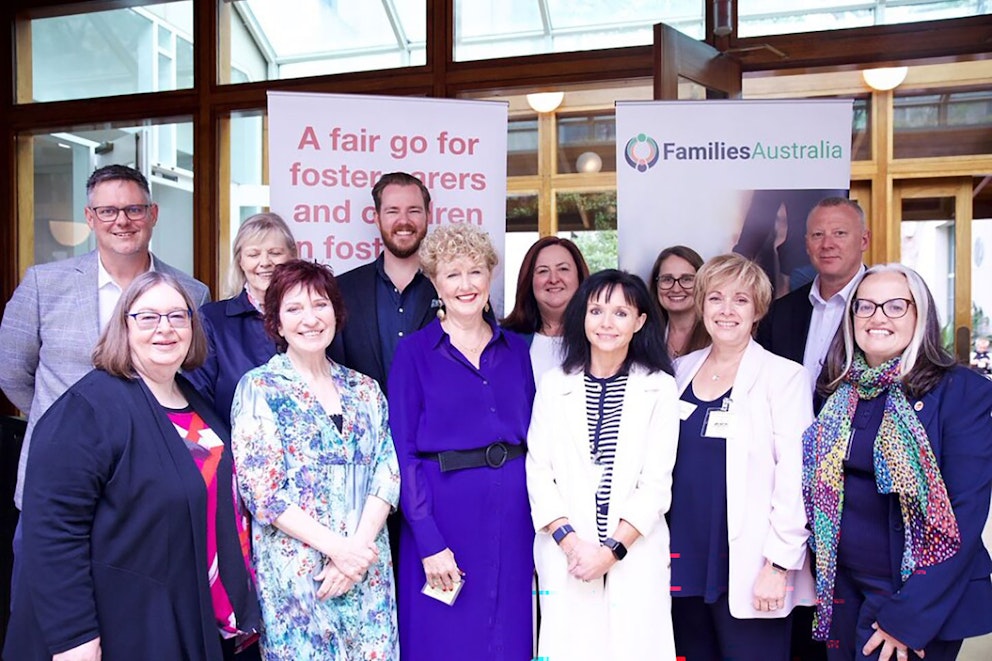 A group of foster carers, young people and representatives from Key Assets Australia and Families Australia posing together at Parliament House during the relaunch of the Parliamentary Friends of Foster Carers and Children in Foster Care.