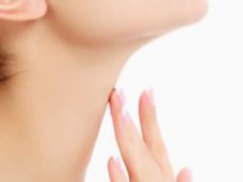 woman touching her neck