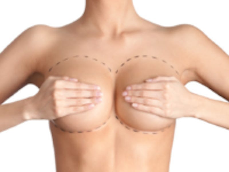 woman holding both her breasts in her hands