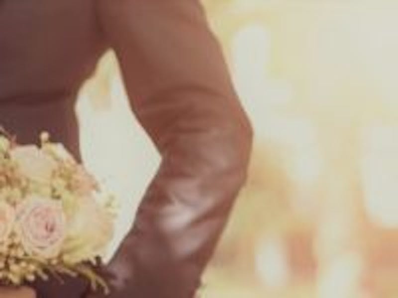 bride and groom posing with bouquet