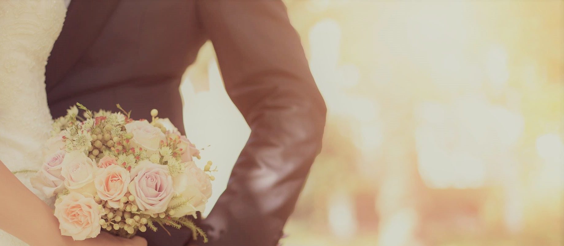 bride and groom posing with bouquet