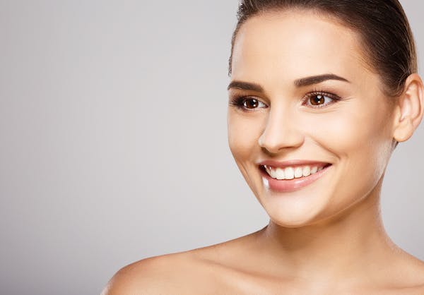 Smiling woman with her hair pulled back