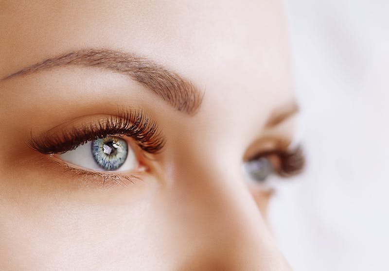 Close up of a white woman's blue eyes and sculpted eyebrows