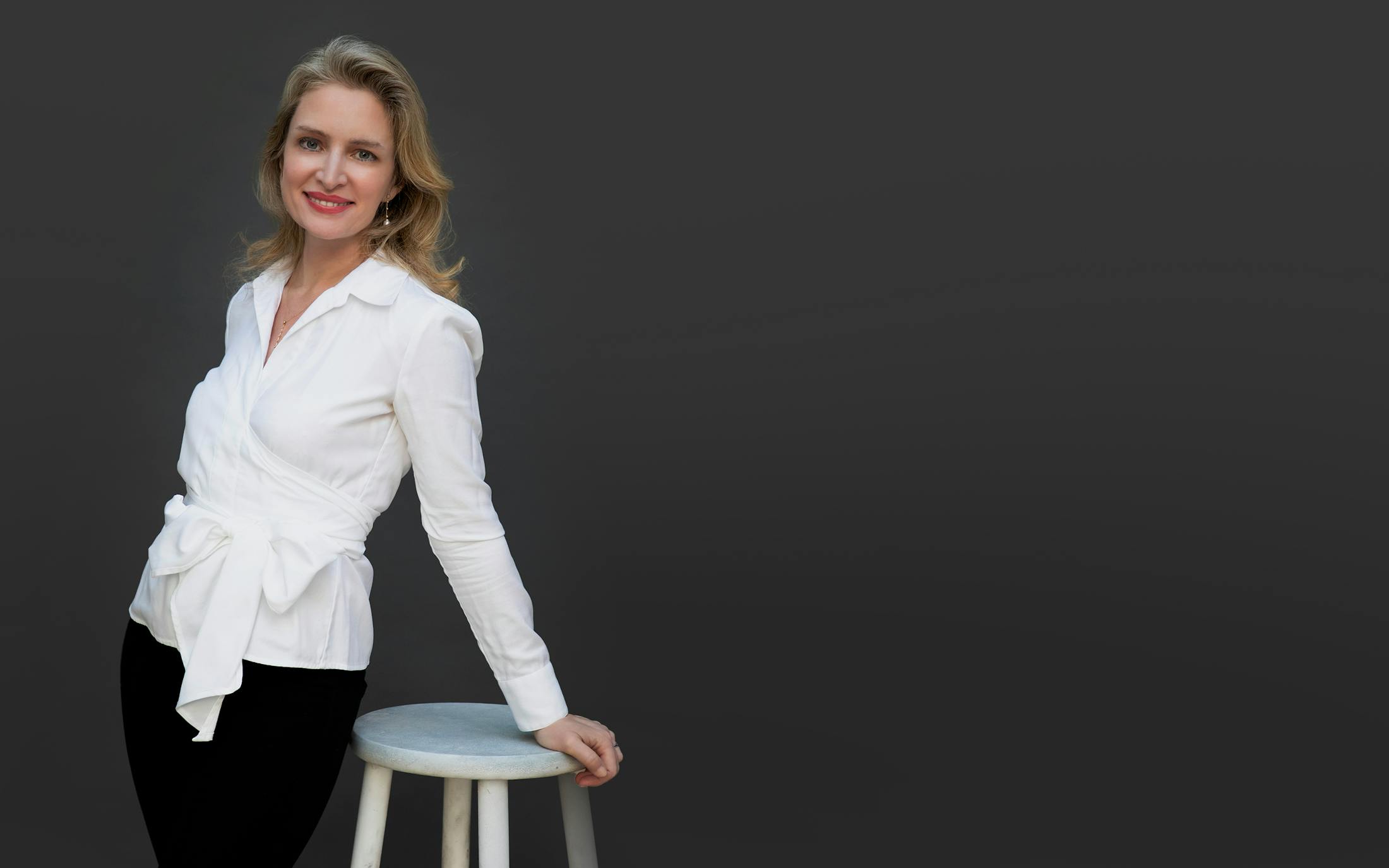 Dr. Olivia Hutchinson Leaning on Stool