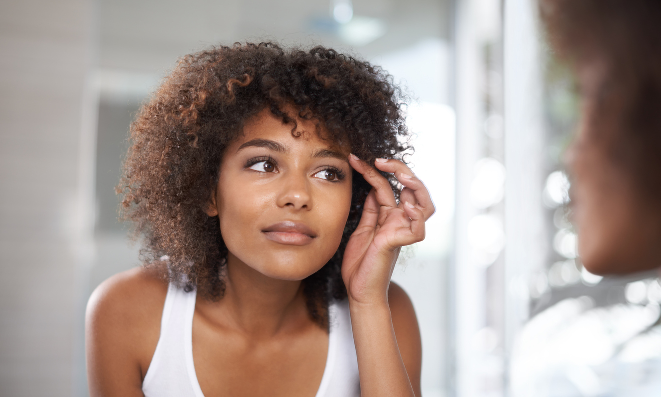 Woman looking at her eyes