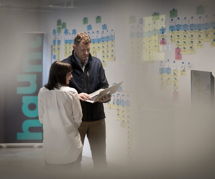 A man and lady look at a laptop