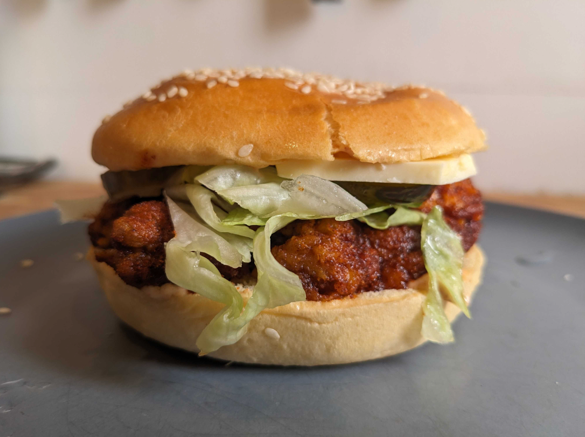 a deep friend chicken sandwich with lettuce, cheese and mayo