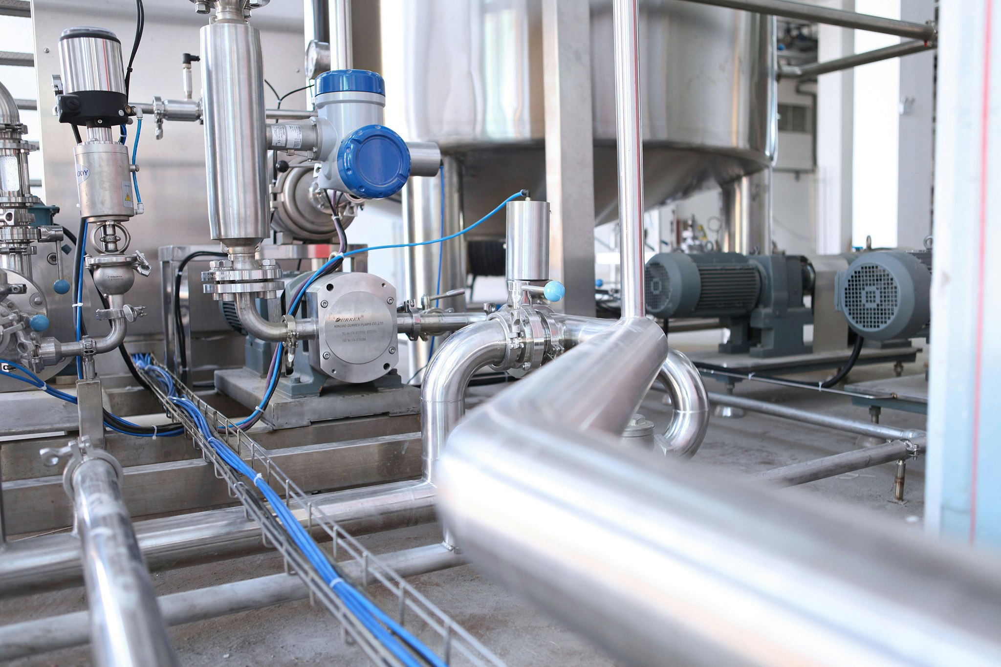 Interior of a factory with steel containers and pipes