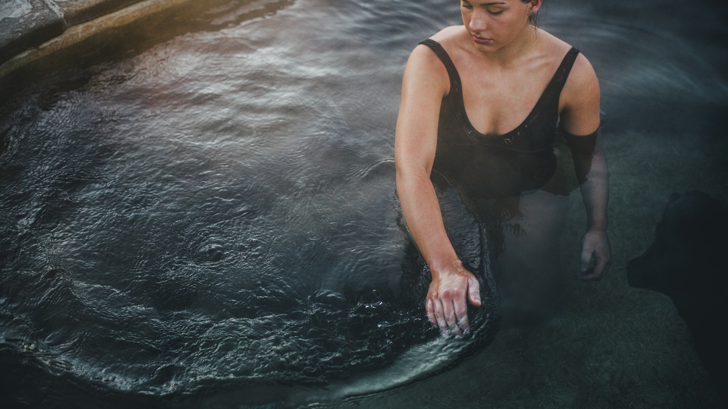 Woman wading through hot water bath