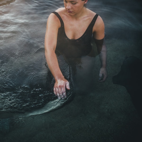 Woman wading through hot water bath