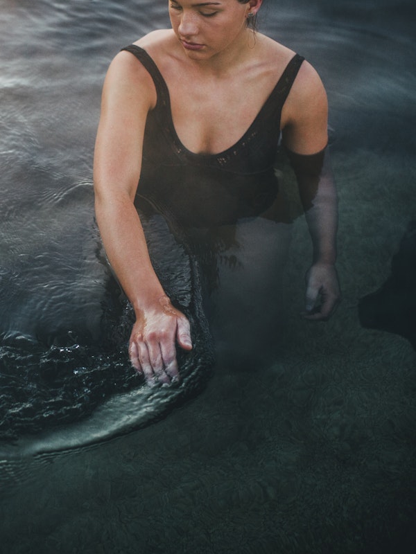 Woman wading through hot water bath