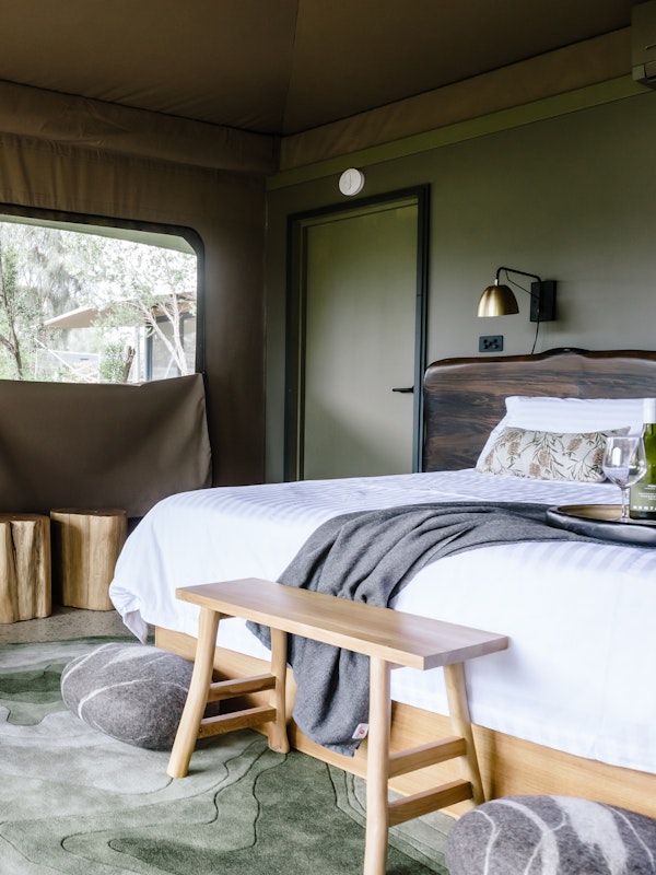 Bed and couch inside Glamping tent