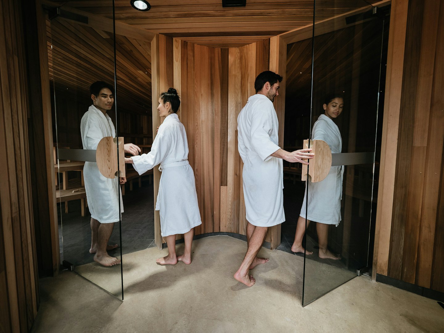 couples dressed in robes enter saunas
