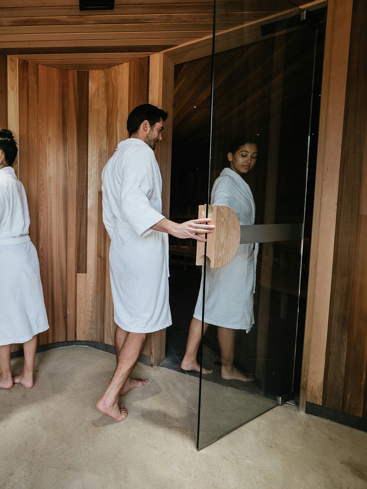 couples dressed in robes enter saunas
