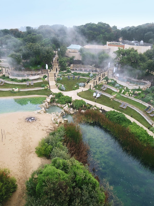 Aerial shot of peninsula hot springs' amphitheatre pools, lake and stage