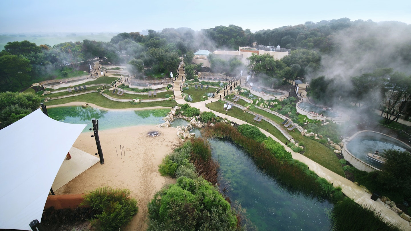 Aerial shot of peninsula hot springs' amphitheatre pools, lake and stage
