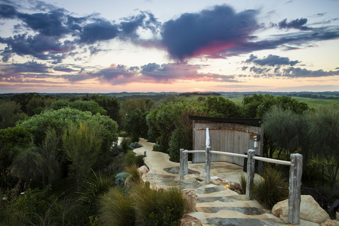 view from hilltop pool at sunrise pink skies