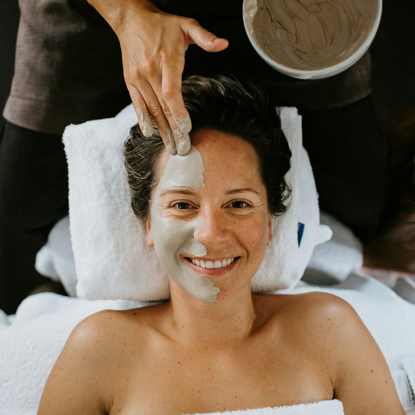 girl smiling during a facial