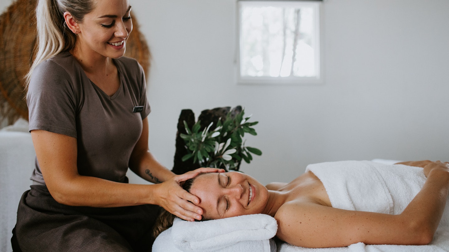 spa therapist massaging guest's head