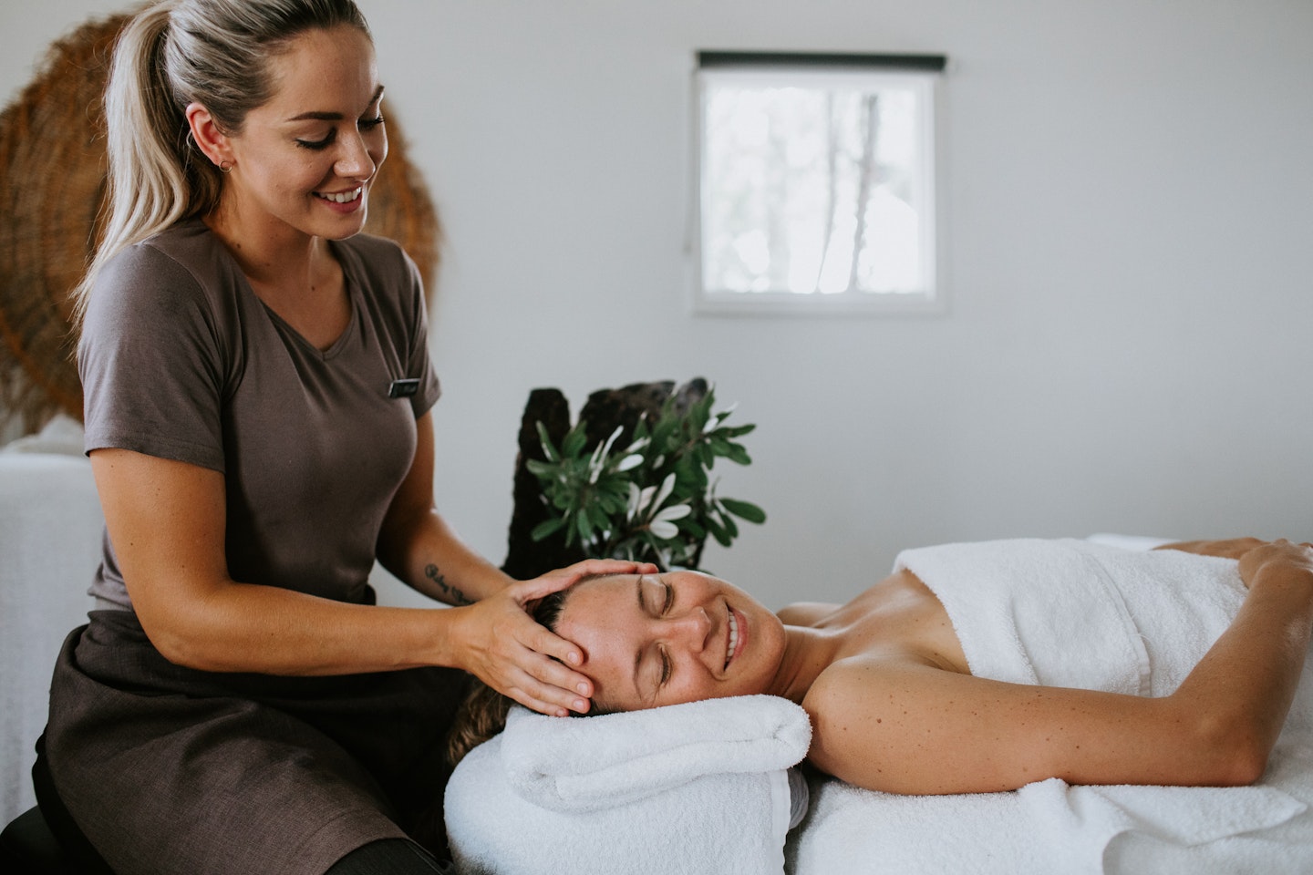 spa therapist massaging guest's head