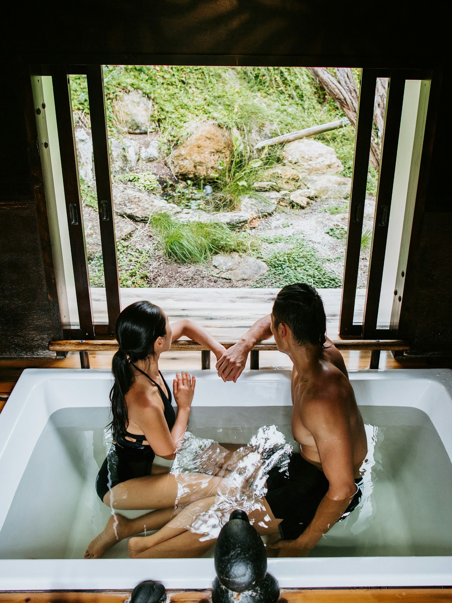 couple sitting in private bathing pavilion looking out at view of nature