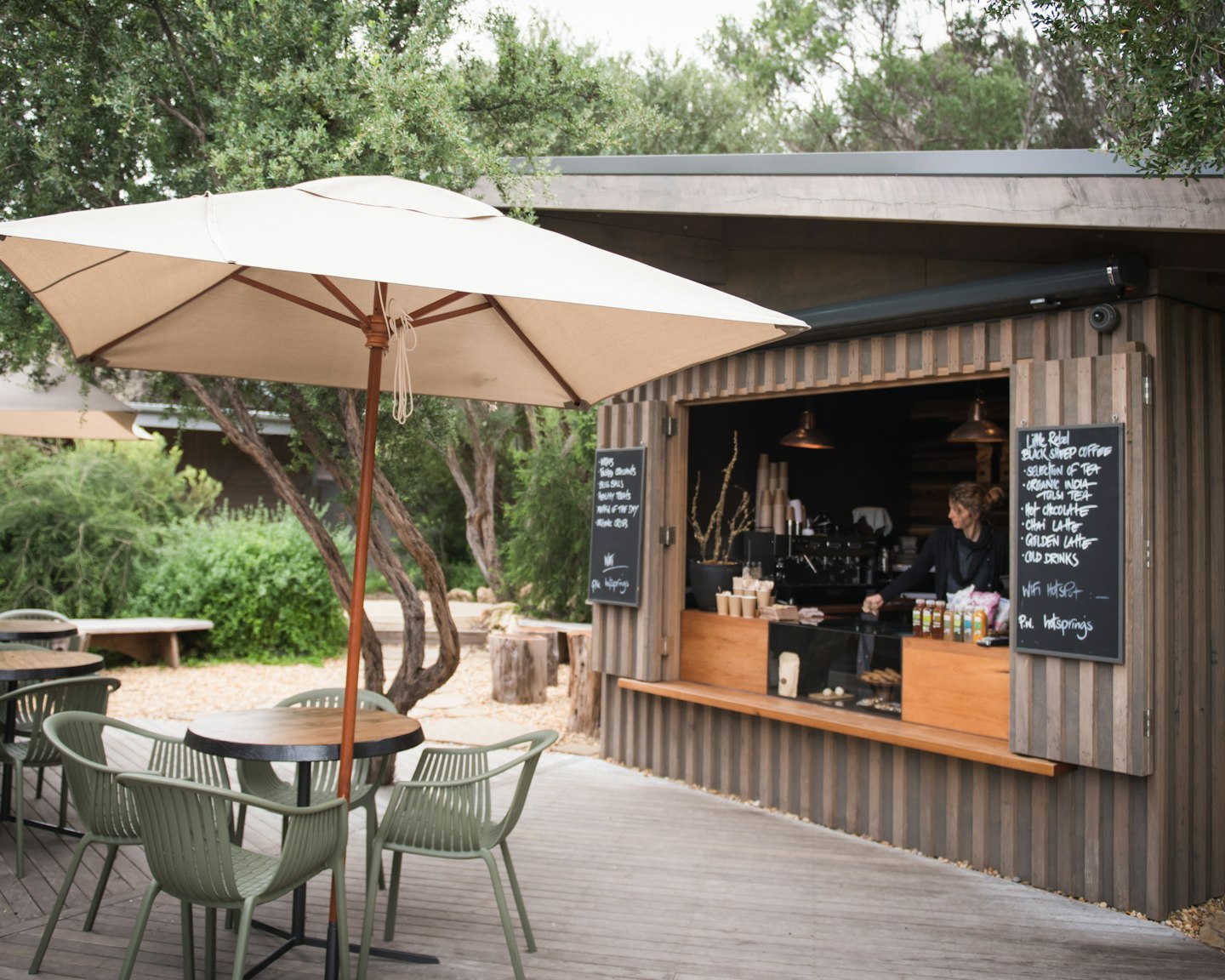 coffee hut with outdoor tables, chairs and umbrellas
