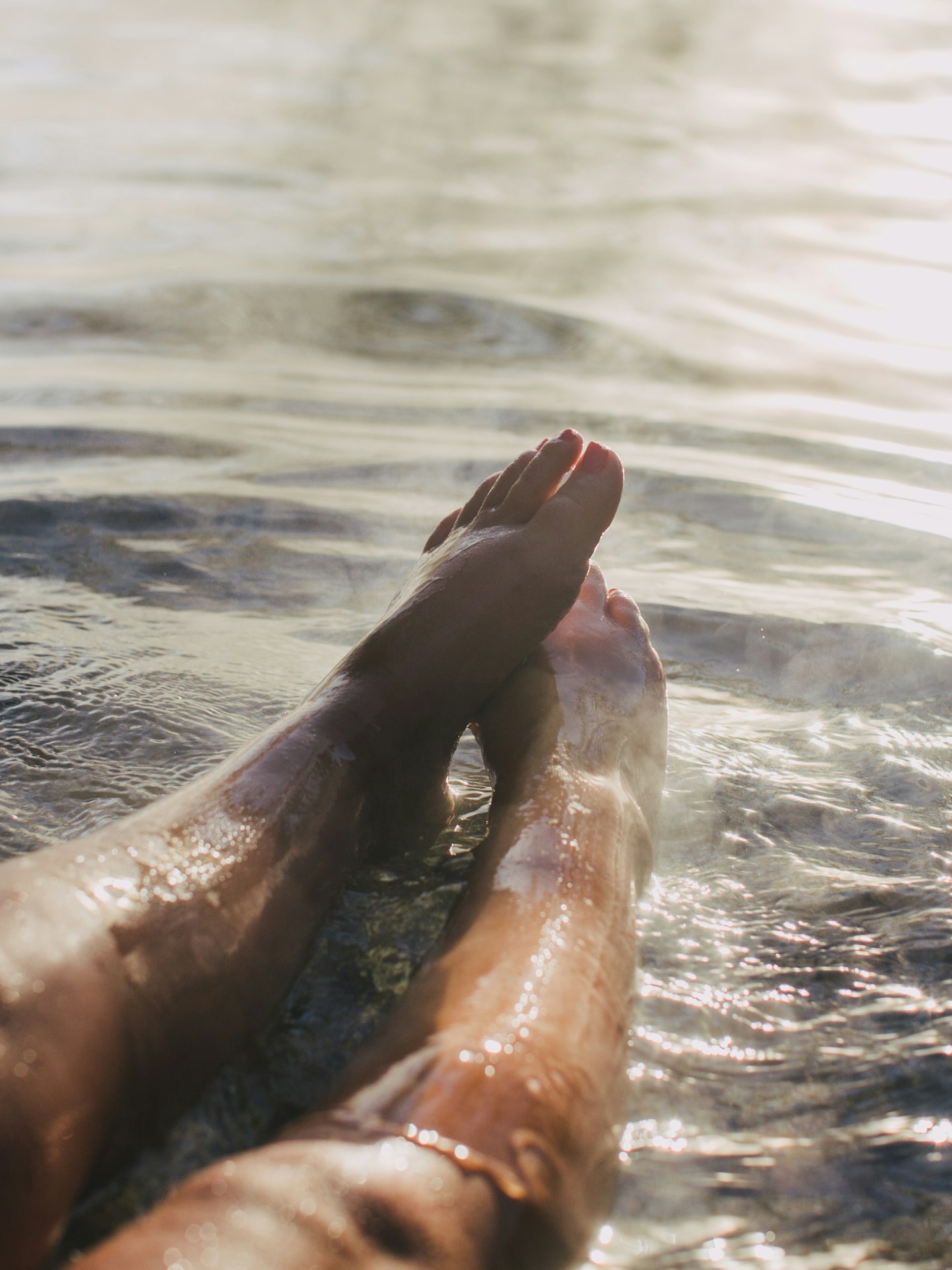 ladies legs and feet stretched out in geothermal water