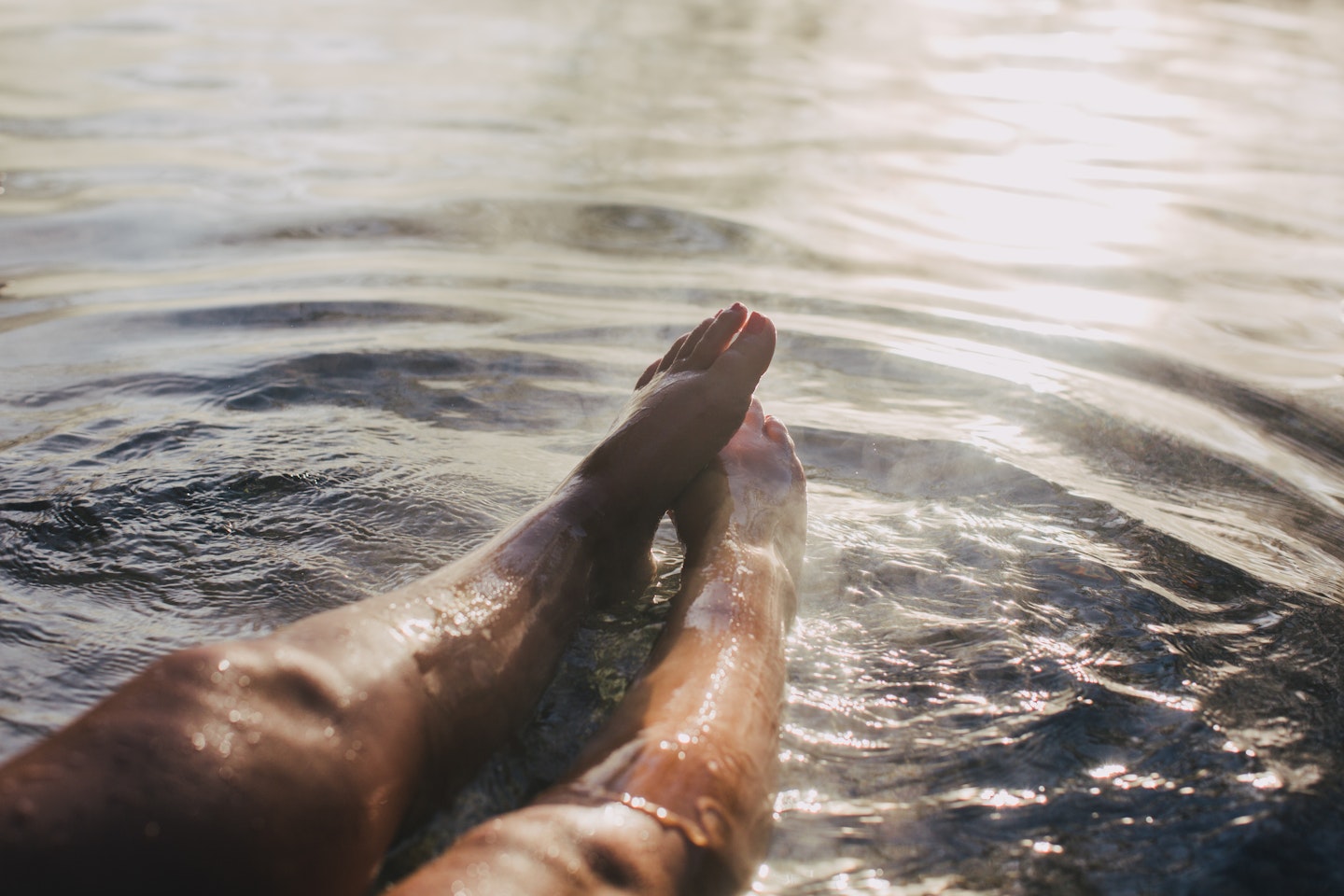 ladies legs and feet stretched out in geothermal water