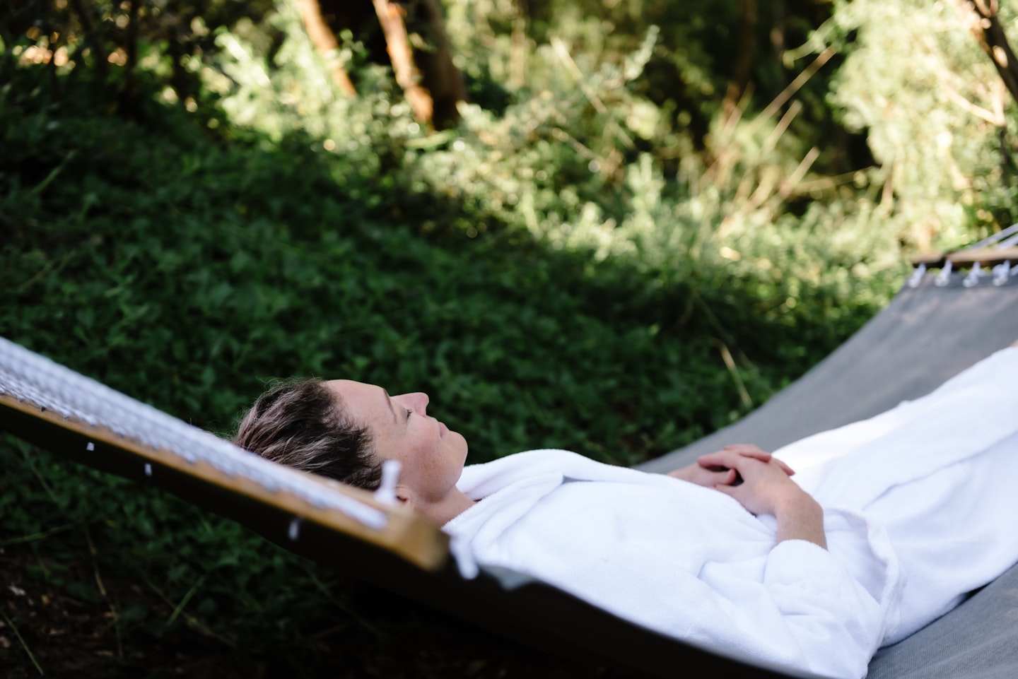 a woman lying in a hammock