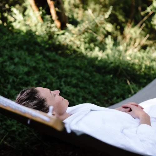 a woman lying in a hammock