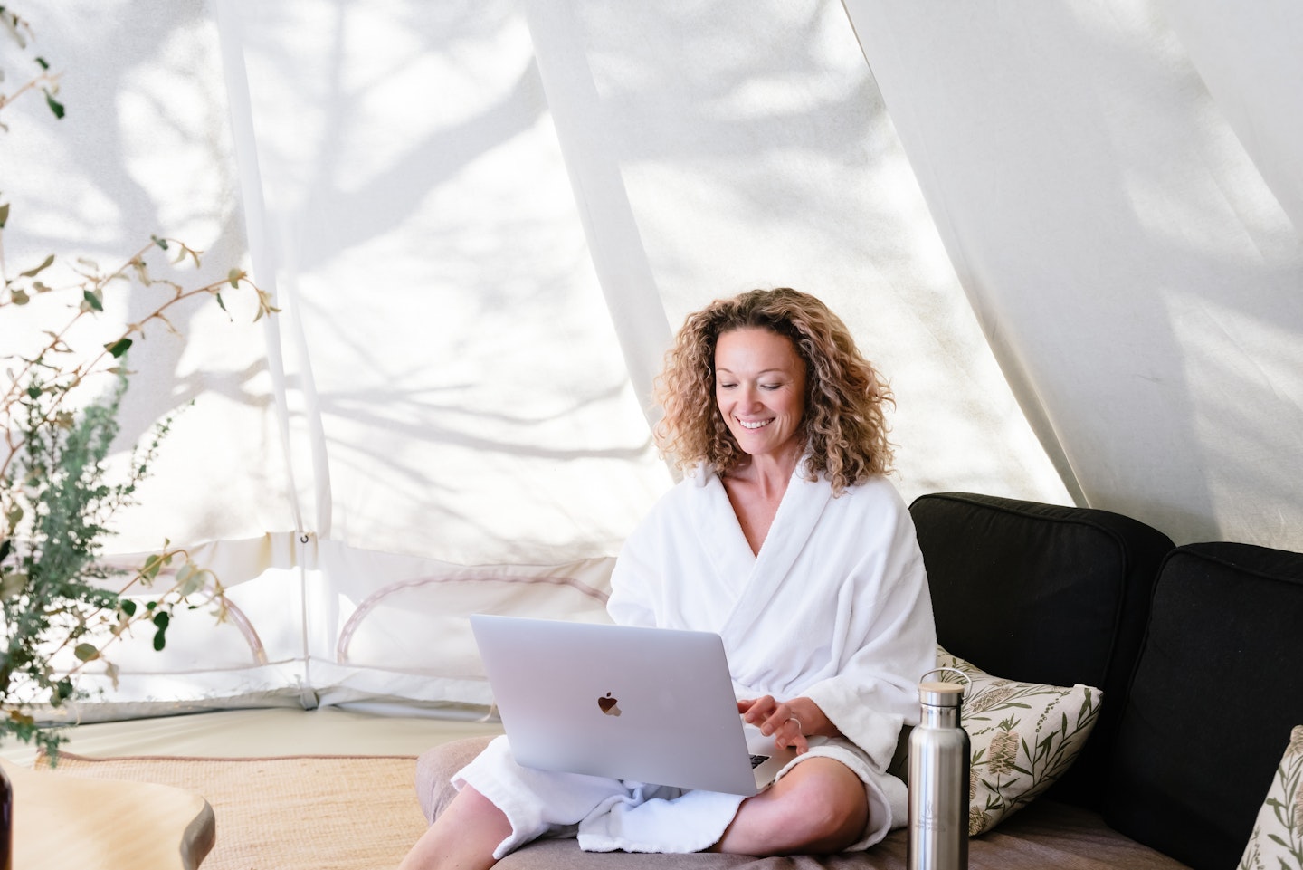 lady working on laptop in relaxation cabana