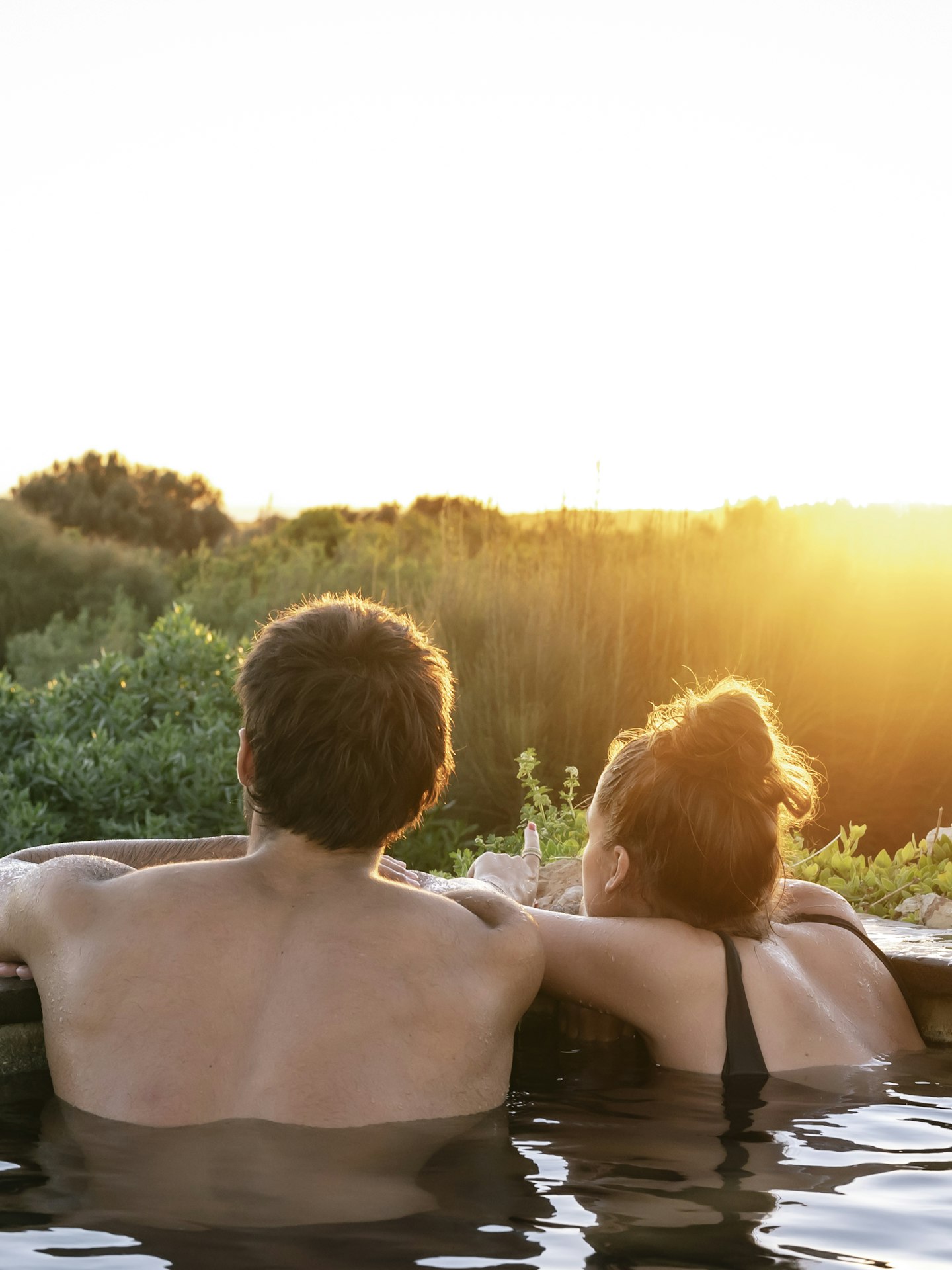 couple in hot pool looking out at view