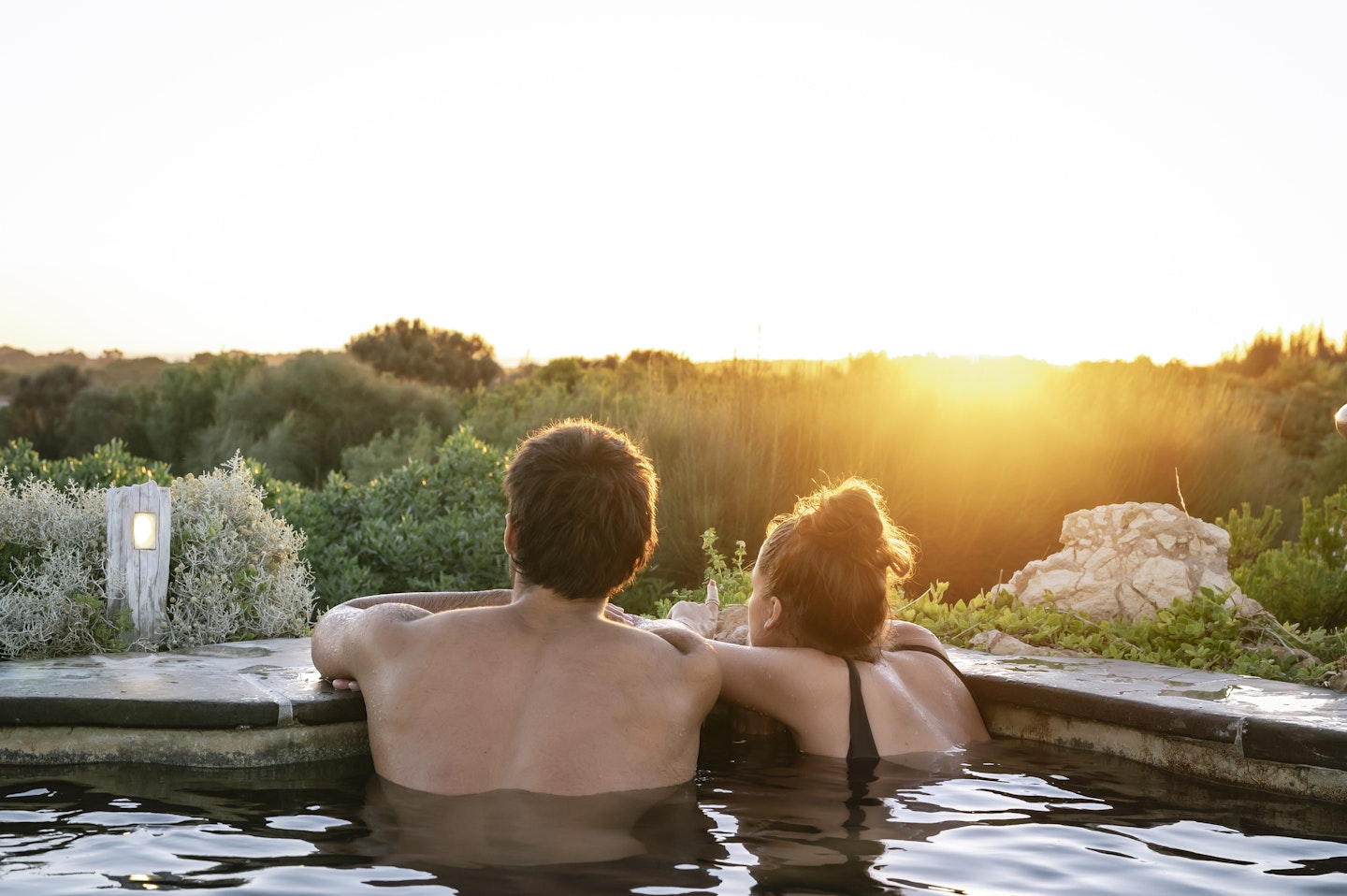 couple in hot pool looking out at view