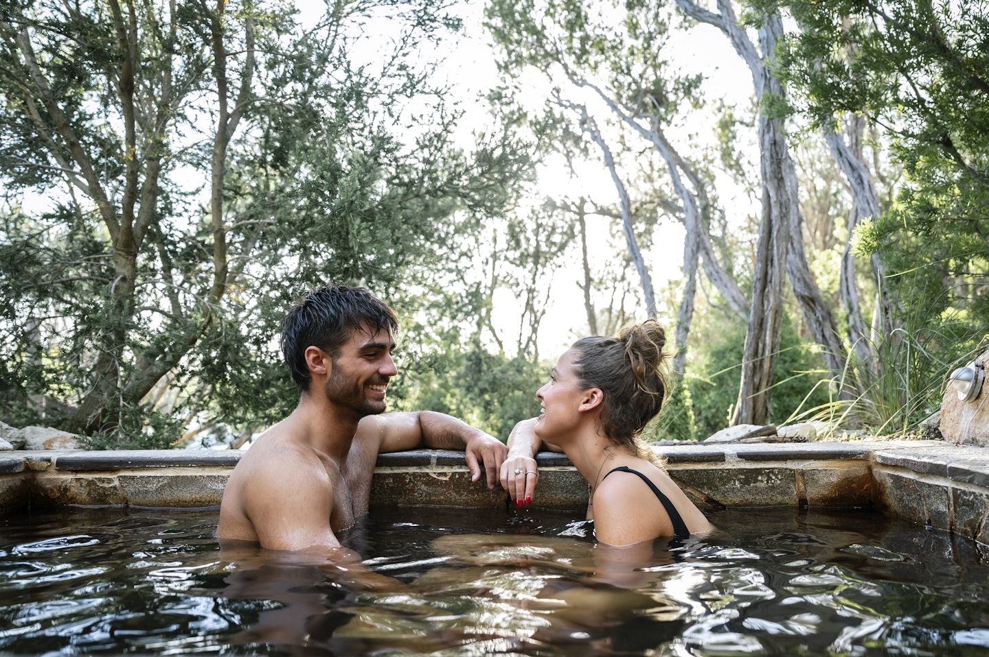 couple sitting in hot geothermal pool