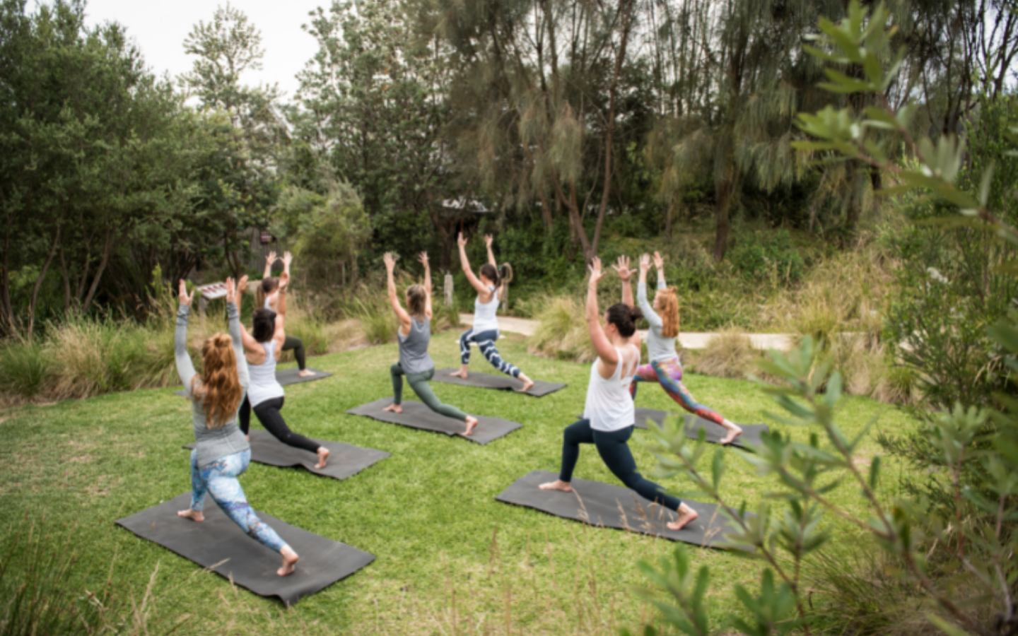 group of women doing yoga in natural surrounds of peninsula hot springs
