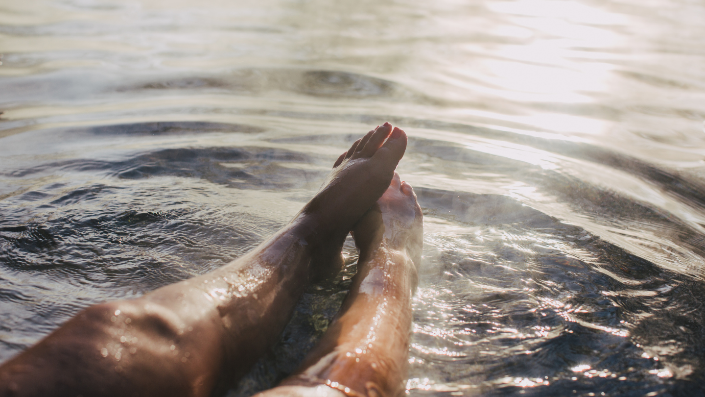 woman's legs outstretched in geothermal water