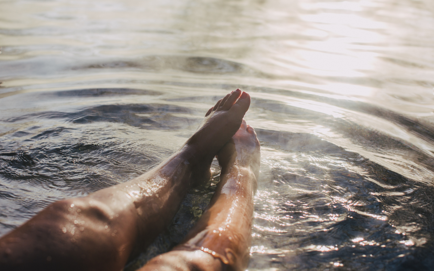 woman's legs outstretched in geothermal water