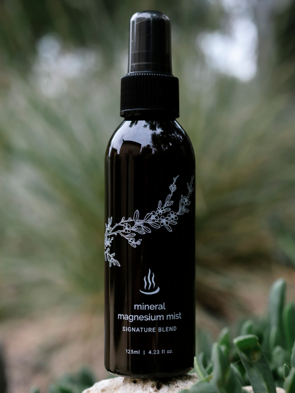 125ml spray bottle of mineral magnesium mist sitting in natural surrounds