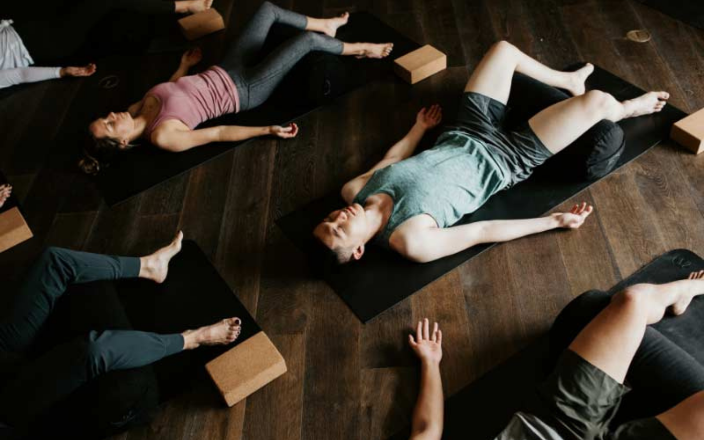 people meditating in shavasana yoga pose
