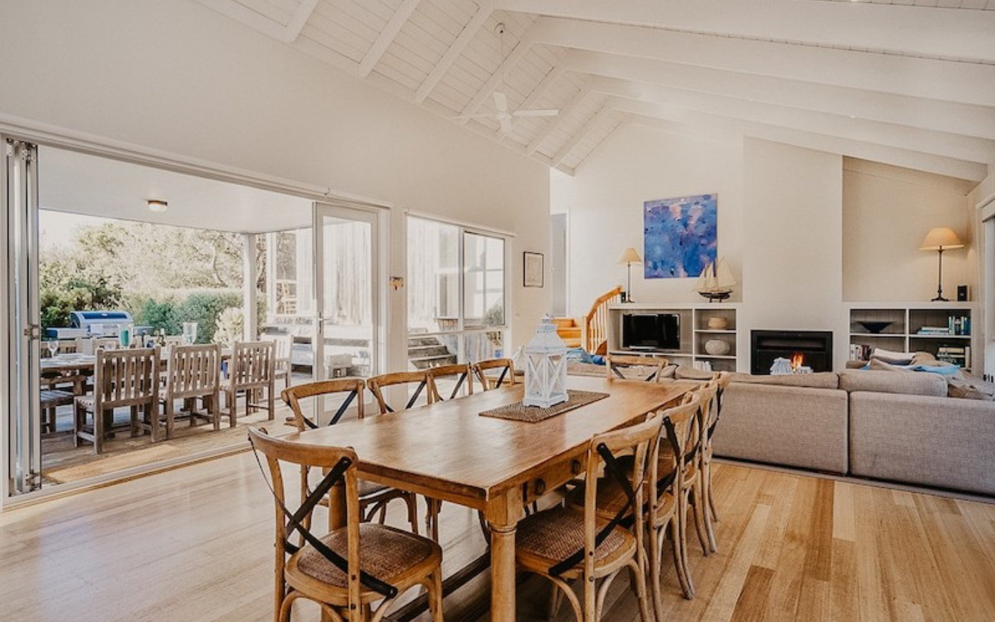 beach house living and dining area with outdoor barbeque area 