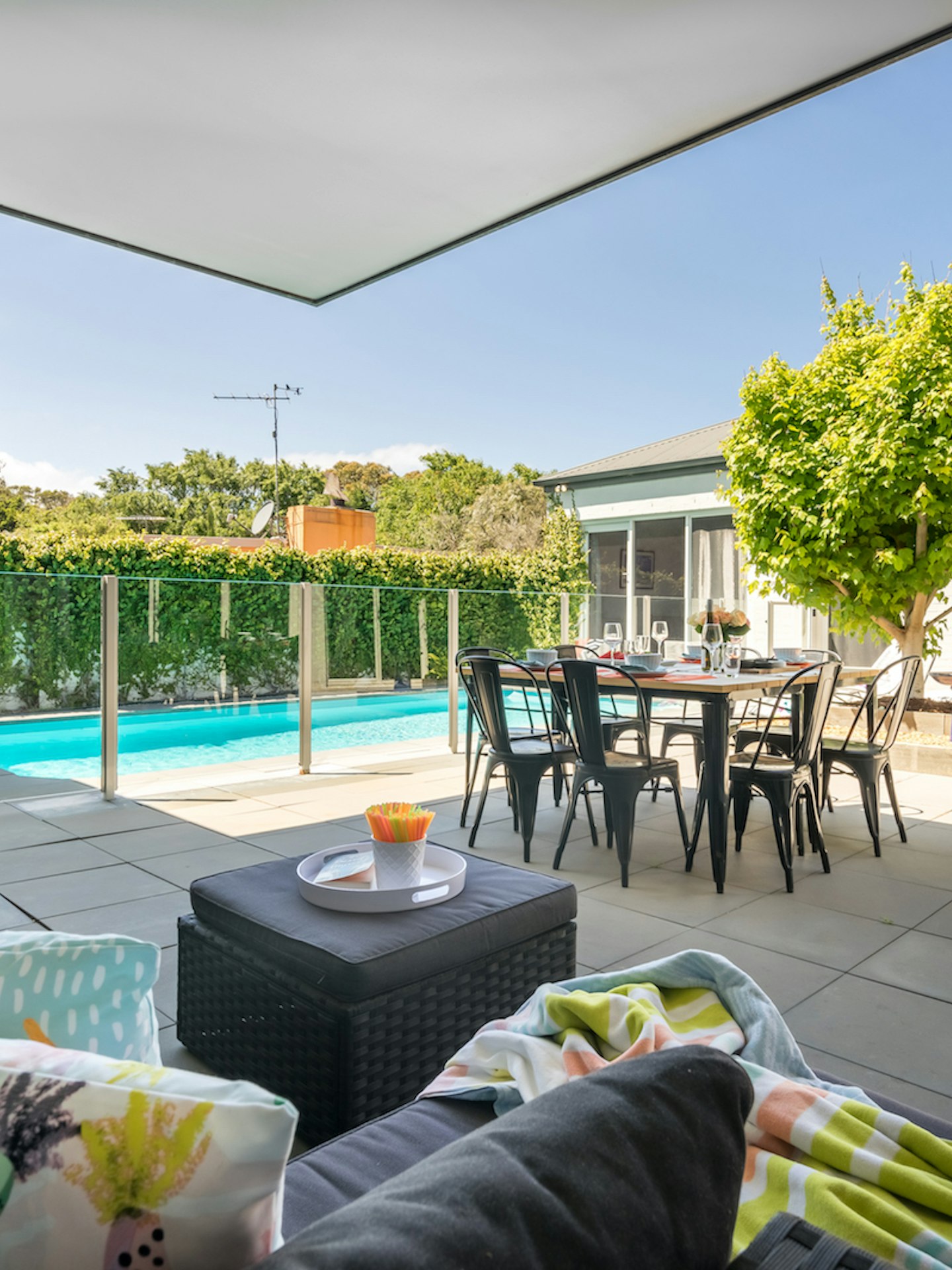 view of inground pool, outdoor dining and barbeque from outdoor sofa