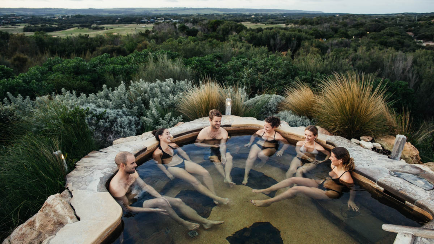 A group of six friends bathing in the hilltop pool