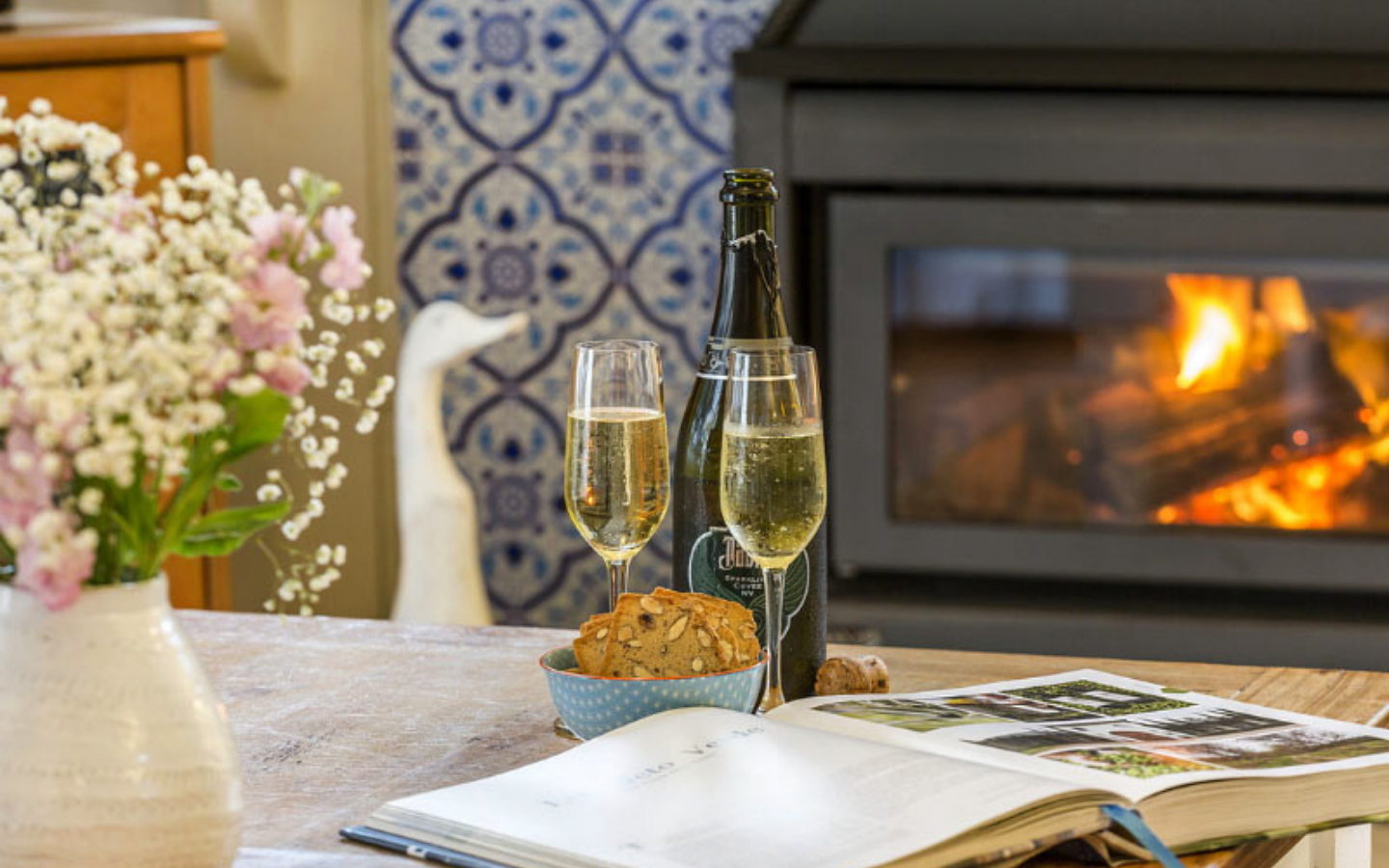 champagne glasses in front of wood burning heater