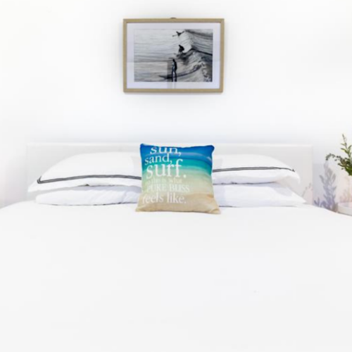 guest bedroom with white bed linen and surf coast styling