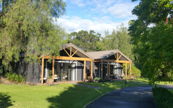 external view of cabin style retreat in beautiful gardens