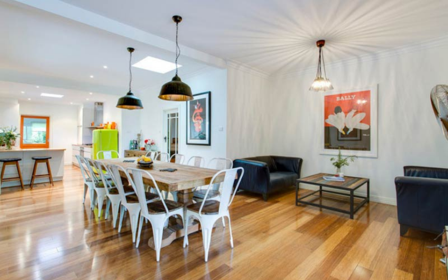 view of large dining table and kitchen in background